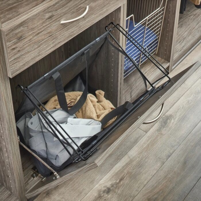 Tilt-out laundry hamper inside cabinetry